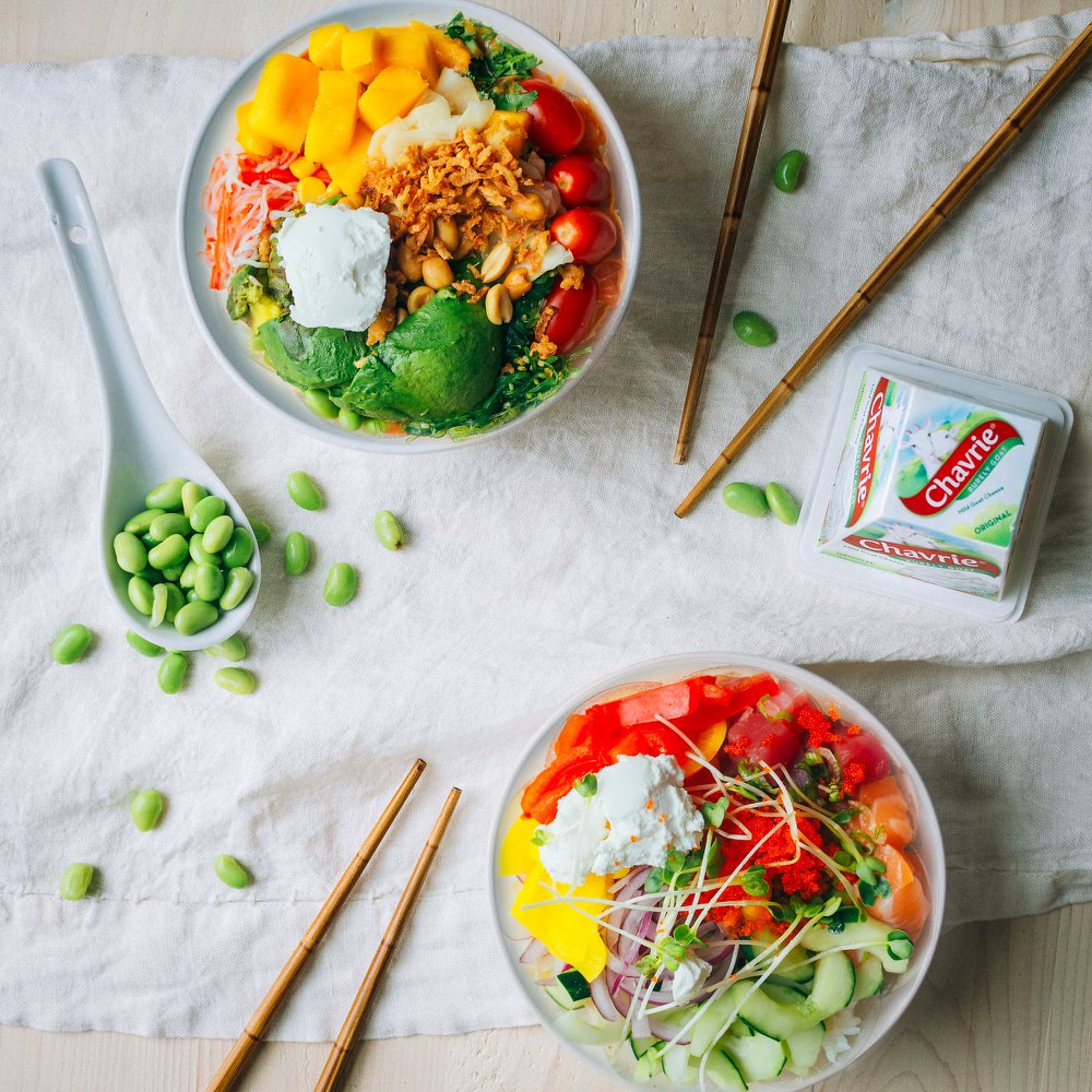Colorful poke bowls with rice, vegetables, fruits et Chavrie goat cheese pyramid