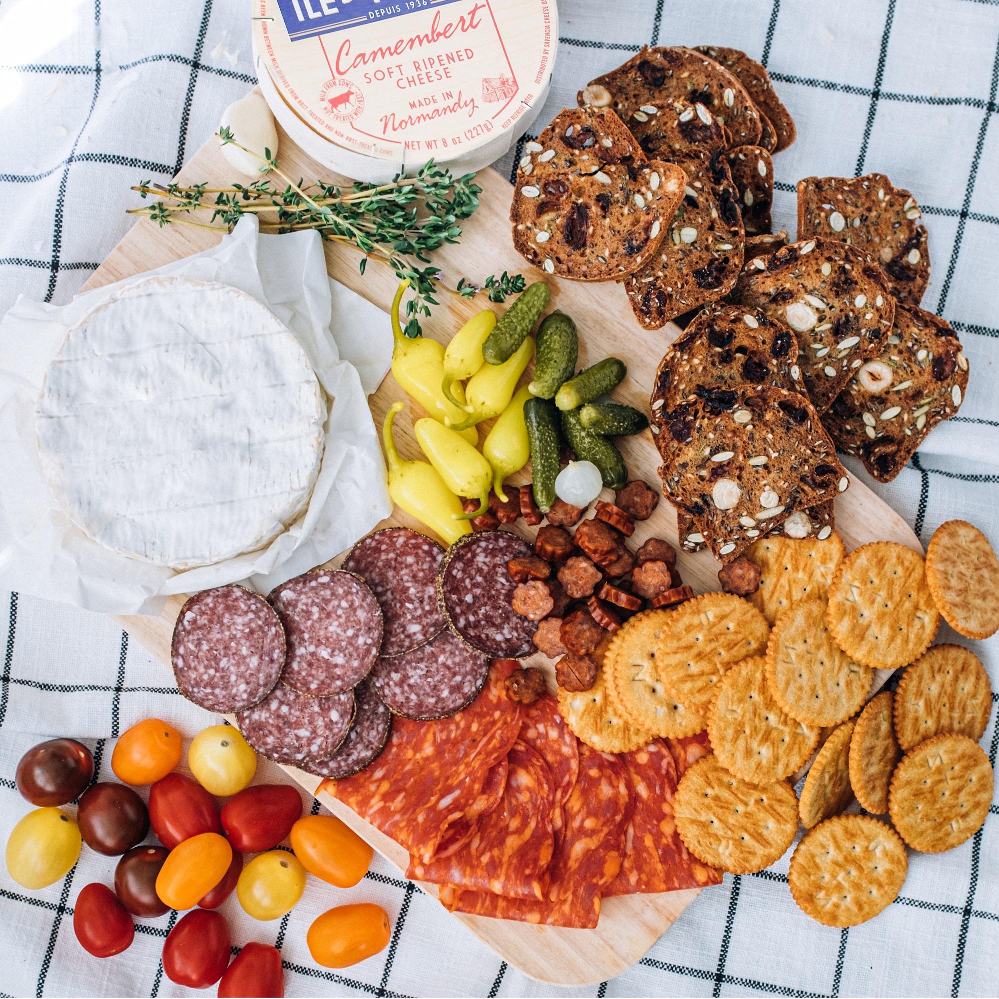 apero platter with ile de france camembert, charcuterie, vegetables and crackers