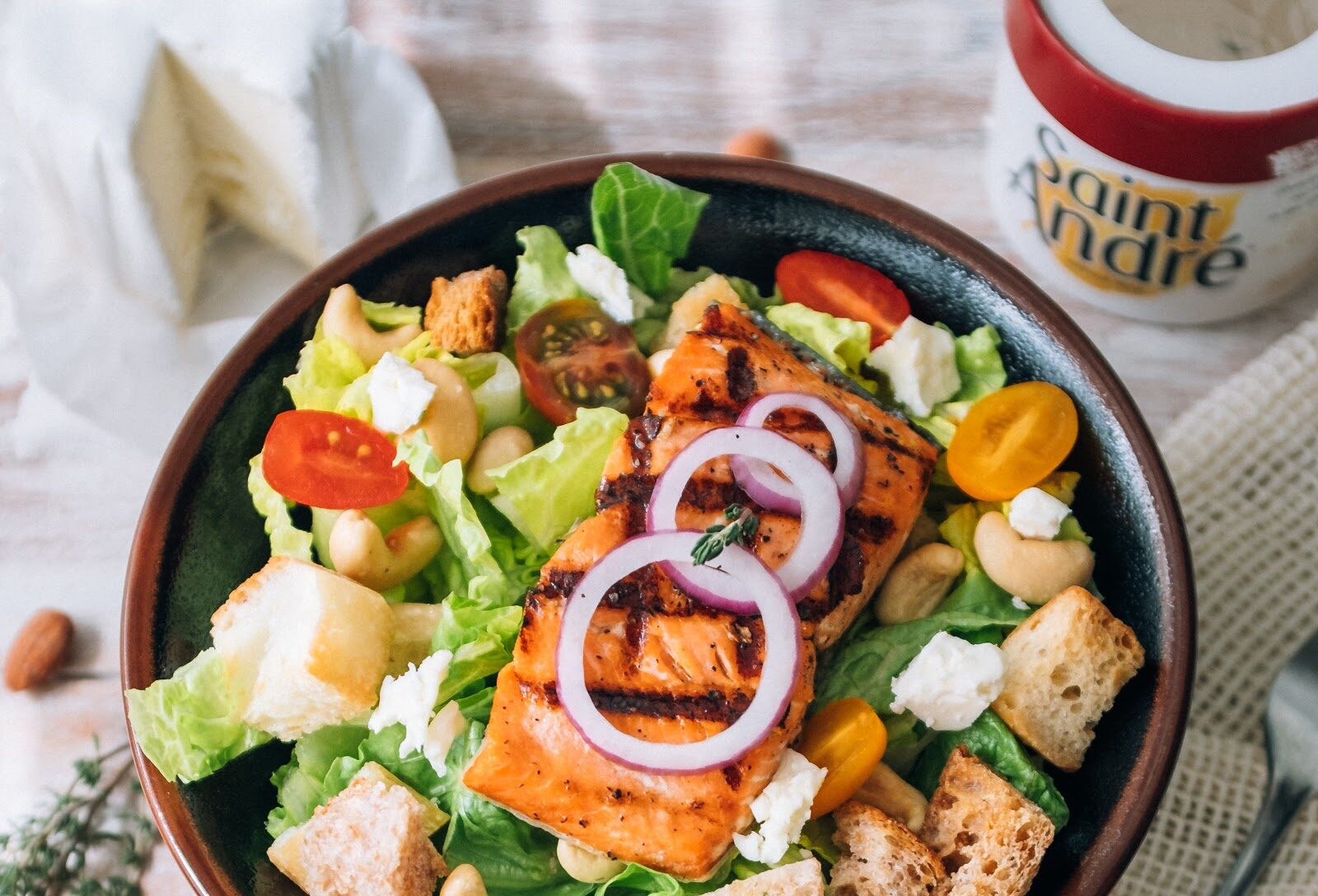 salad bowl with baked salmon and saint andré cheese